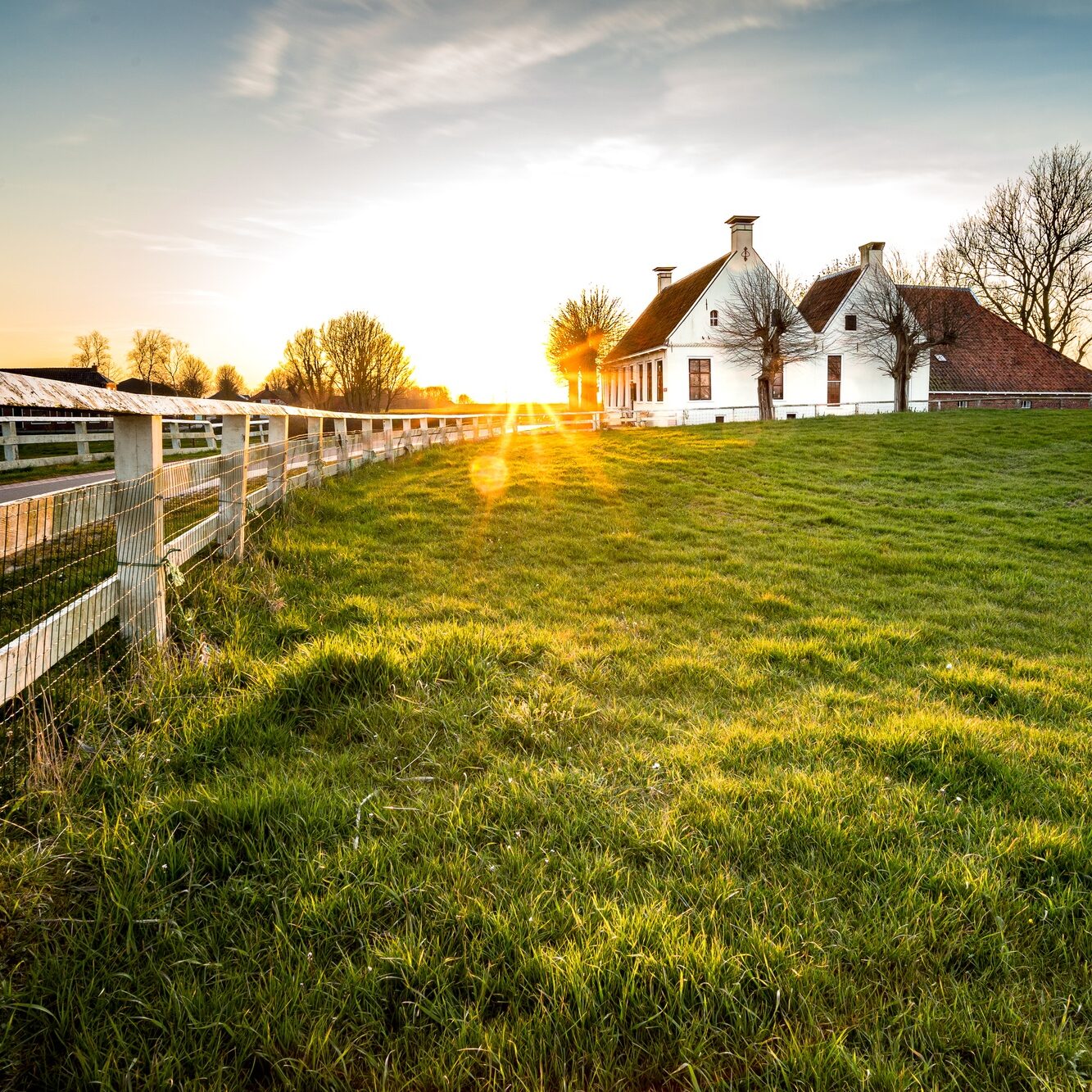 beautiful-shot-fence-leading-house-green-grass-area